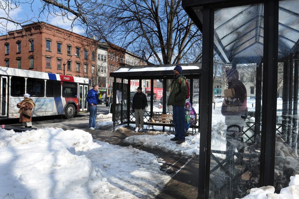 KEVIN GUTTING Personal space observed while waiting for the B48 at the PVTA bus stop in front of the Academy of Music Theatre on Main Street, Northampton, on Wednesday afternoon, February 25, 2015. - KEVIN GUTTING | Daily Hampshire Gazette
