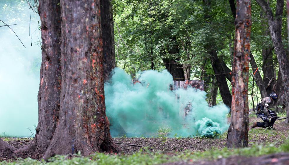 MICKY BEDELL A paintballer rushes towards the opposition under cover of a smoke grenade at Agawam Xtreme Paintball on Sunday afternoon. - Micky Bedell |
