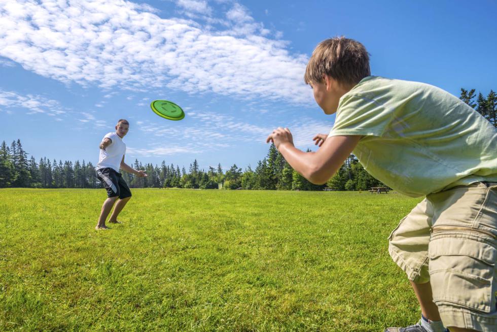 Boys playing a frisbee - PetrovVadim | iStockphoto
