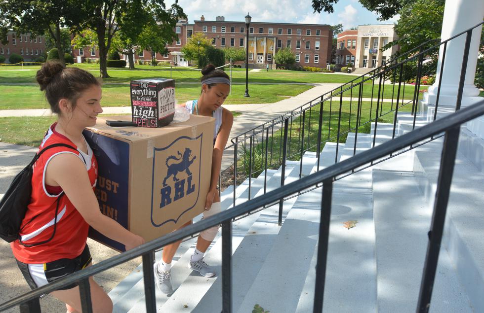 JERREY ROBERTS Federica Frew, left, and Taylor Kue move items into their dorm room Wednesday at American International College. They are freshmen, and members of the soccer team. - JERREY ROBERTS | DAILY HAMPSHIRE GAZETTE
