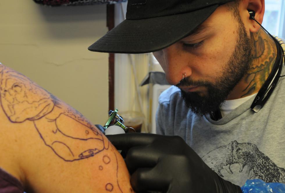 CAROL LOLLIS Breanne Ryan receiving a tattoo by Andre Cheko. - Carol Lollis | Daily Hampshire Gazette
