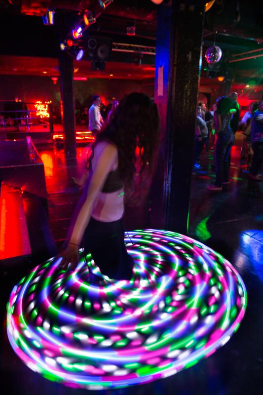 DAN LITTLE Kim Knowlton, of Northampton, spins on the dance floor with an illuminated hula hoop at Diva's Nightclub Saturday night in Northampton. - DAN LITTLE | DAN LITTLE

