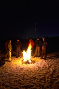 Large group of people around fire outdoors - Jupiterimages | Photos.com
