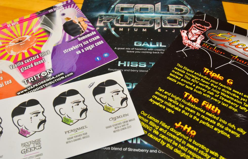 Marketing flyers from vape companies rest on the counter at Voltage Vape in Springfield, Tuesday, March 8. - JERREY ROBERTS | DAILY HAMPSHIRE GAZETTE