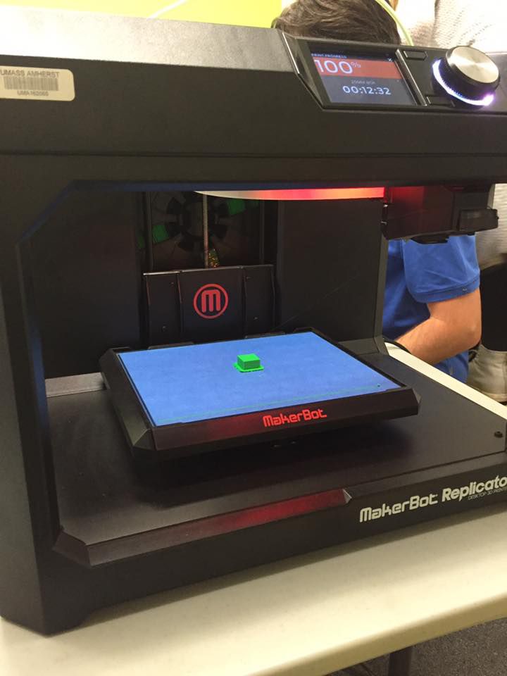 A 3D printer prints out plastic building blocks.