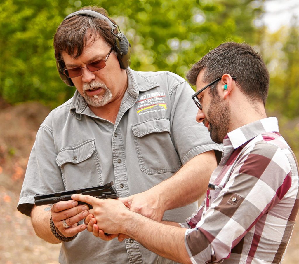 Kirk Whatley, left, instructs Valley Advocate reporter Hunter Styles during a group firearms training class Saturday at Norwottuck Fish and Game in Amherst.