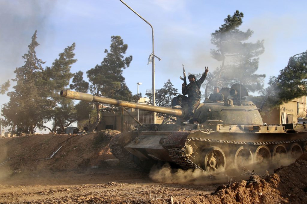 Alexander KotsFILE - In this file photo taken on Wednesday, Feb. 17, 2016, a volunteer fighter with the Syrian Government forces sits atop a tank in the province of Raqqa, Syria. A two-pronged advance to capture key urban strongholds of the Islamic State and its self-styled capital of Raqqa has underlined a quiet convergence of strategy between Washington and Moscow to defeat the extremist group, with Syria’s Kurds emerging as the common denominator.  (Alexander Kots/Komsomolskaya Pravda via AP, File)