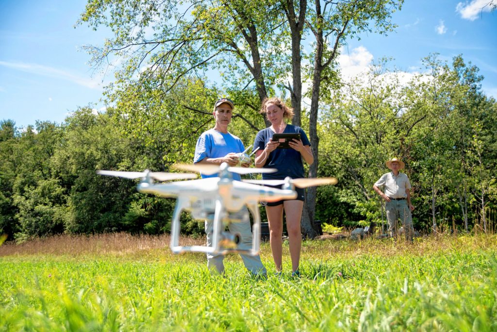 Gazette Staff/Andrew Whitaker—Andrew J. Whitaker/Gazette StaffFrom left, Jon Caris, Lizzie Sturtevant and Paul Wetzel guide the drone back to ground control during the Spatial Analysis Lab flight demonstration at Smith College's Macleish Field Station Tuesday, August 9, in Whately.