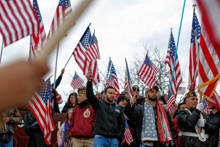 Hundreds rally at Hampshire College on Nov. 27, 2016 to protest the school's decision to hold off on hoisting the flag in the center of the Amherst campus. Hampshire College removed the U.S. flag indefinitely after, since Election Day, it has been set ablaze, replaced, and lowered to half-staff.