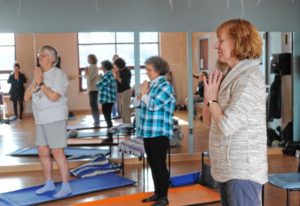 From left, Suzanne Carlson of Greenfield, Kim Audette of Sunderland and Karen Latka of Montague participate in a yoga class for people dealing with cancer at the Greenfield YMCA.   February 22, 2017.