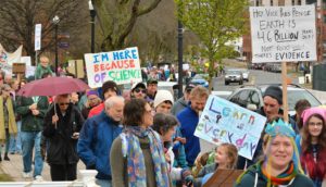 Hundreds of people walk in the March for Science on North Pleasant Street in Amherst on Earth Day, Saturday.