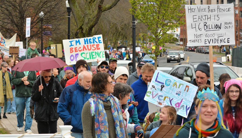 Hundreds of people of all ages walk in the March for Science on North Pleasant Street in Amherst on Earth Day, Saturday.