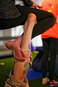 Brian Begley of Pittsfield, left, and Kirsten Jarvis of Easthampton interlock limbs in straddle throne pose March 31, 2017 during an acroyoga meet up at Mill 180 Park in Easthampton.