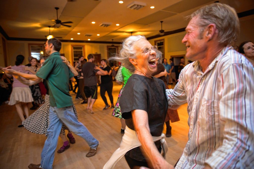 Tina Olsen, 73, of Brattleboro, dances with David Cantieni, Master of the Guiding Star Grange in Greenfield during a contra dance Saturday, October 8.