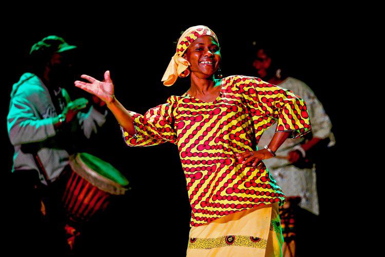 Bountouraby Sylla, an immigrant from Guinea, West Africa, who is now living in Shutesbury, center, performs April 9 during Immigrant Voices: A Celebration of Arts, a showcase of cultural diversity organized by the Northampton-based Center for New Americans and held at the Shea Theater in Turners Falls.