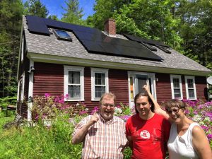 Keith Ross, Simon Ross and Louise Doud in Warwick  pose for a photo in front of the new 6.4 kW solar system on their roof, installed by Co-op Power and NuWatt as one of the first installations for Rays the Valley.