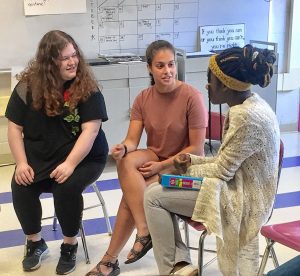 Aviva Weinbaum, center, speaks with other members of the Amherst Regional High School Women's Rights Club Ayla Connor-Kirshbaum, left, and Lourdes Jean-Louis.