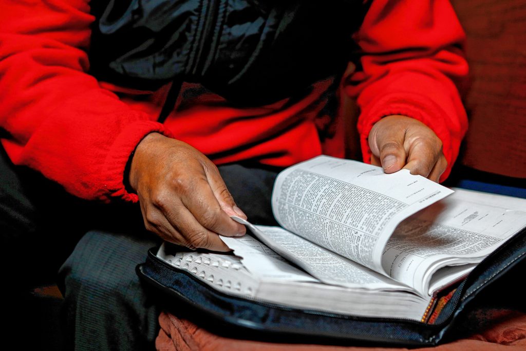 Lucio Perez of Springfield, an undocumented Guatemalan immigrant who is facing deportation, flips to a passage in the Bible that is particularly meaningful to him Nov. 2, 2017 at the First Congregational Church of Amherst, which is providing him sanctuary while he waits for his case to be reopened after Immigration and Customs Enforcement denied his stay of removal.