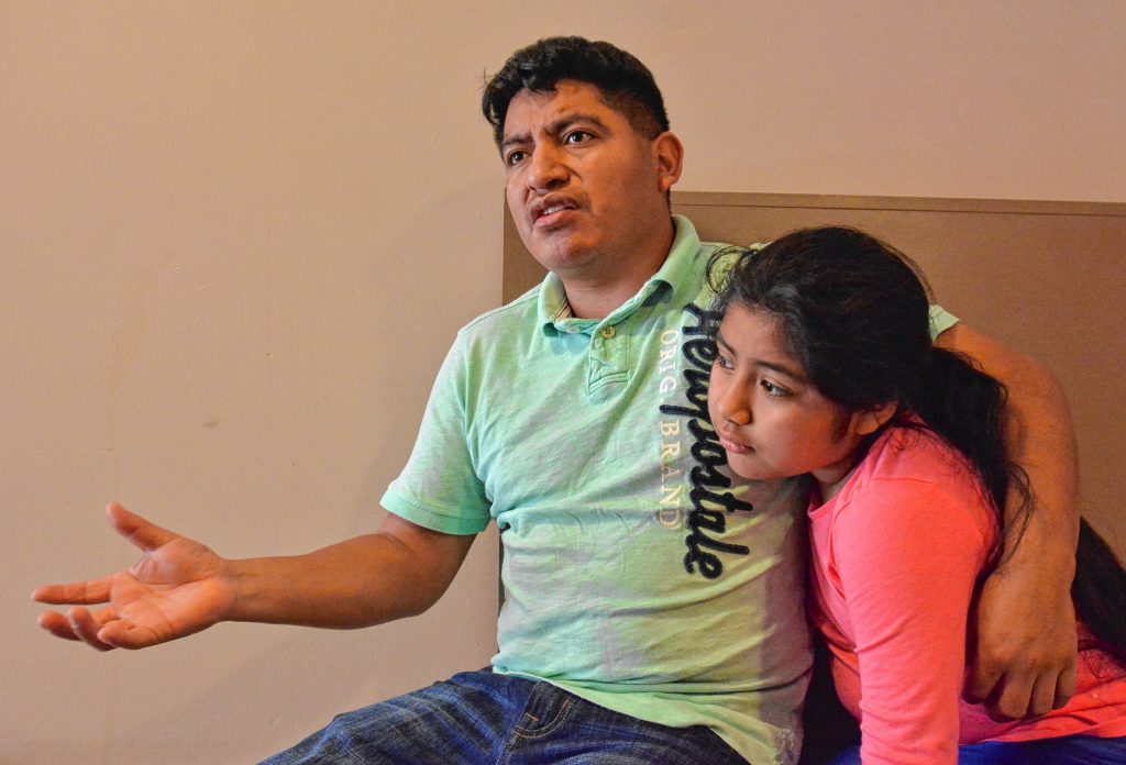 Lucio Perez, of Springfield, who is an undocumented immigrant who was facing deportation until he took refuge at First Congregational Church of Amherst Oct. 18, talks about his predicament, Saturday at the church. He is sitting with his daughter, Lucy, 8.