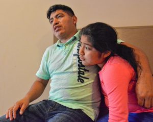 Lucio Perez, of Springfield, who is an undocumented immigrant who was facing deportation until he took refuge at First Congregational Church of Amherst Oct. 18, talks about his predicament, Saturday at the church. He is sitting with his daughter, Lucy, 8.