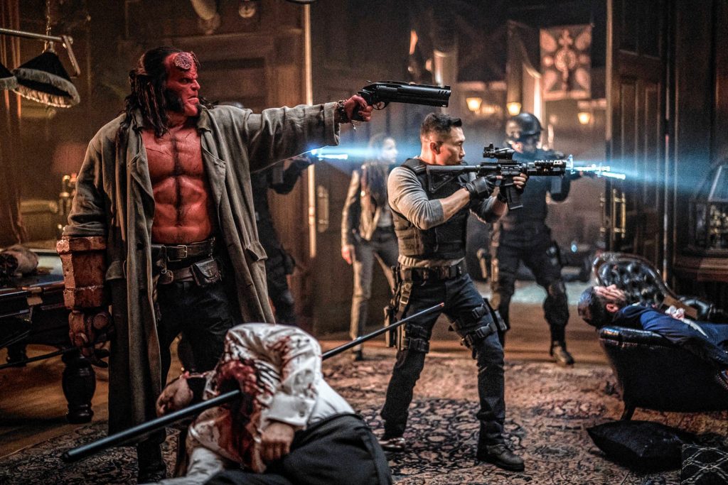 David Harbour as ‘Hellboy’, Sasha Lane as ‘Alice Monoghan’, and Daniel Day Kim as ‘Ben Daimio’ in HELLBOY. Photo Credit: Mark Rogers.