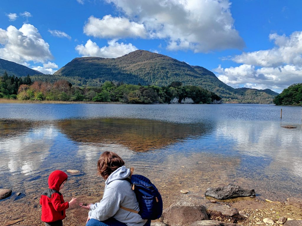 Katie Gartner and her son examine rocks at Muckross Lake in Killarney, Ireland.