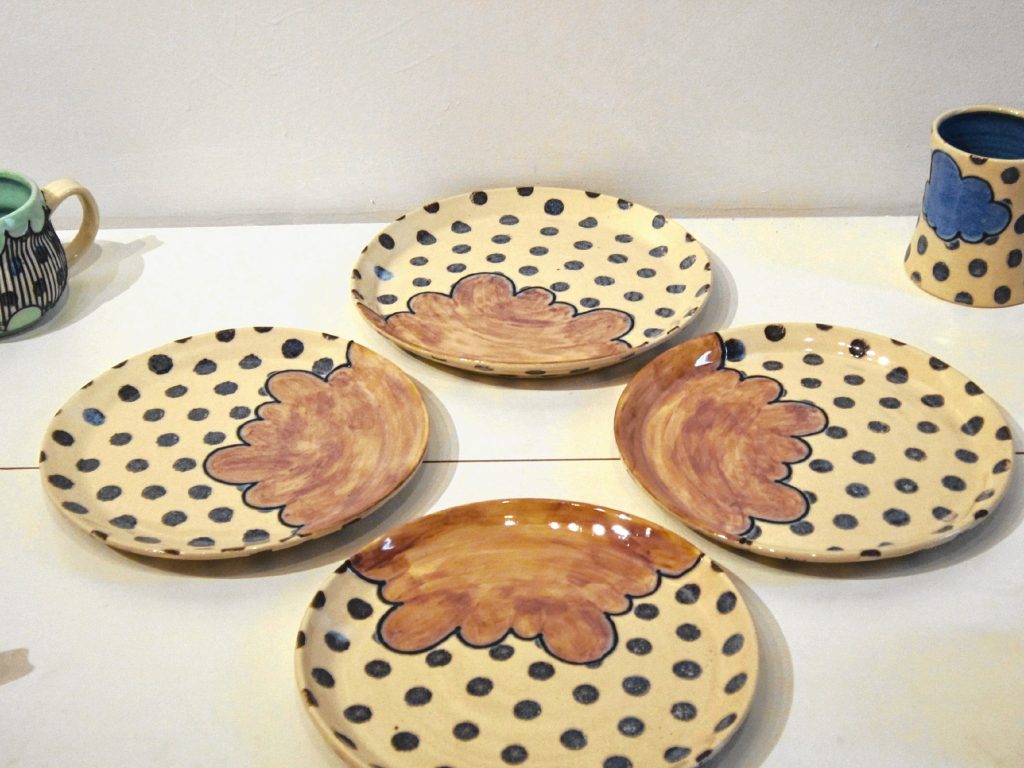 A collection of ceramic plates by artist Kayla McFarland. 