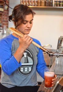Leah Jacobson pours a combination of Bramble Weiss Sour and Original Ginger Beer at New City Brewery in Easthampton, Tuesday, May 28, 2019. Katrina Pierson, the taproom manager said the combination, "mellows the sour taste and adds ginger spice."