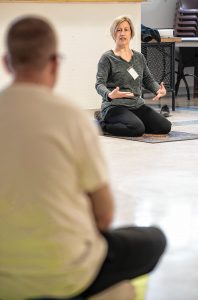 Dori Digenti, owner and founder of Breathing Space Yoga and Mindfulness Studio in Holyoke, leads a "Seeds to Flowers" yoga class for seven men enrolled in the Cultivating, Honoring and Awakening Men's Potential program, or CHAMP, at the Hampden County Pre-Release Center in Ludlow on Tuesday, April 30, 2019.