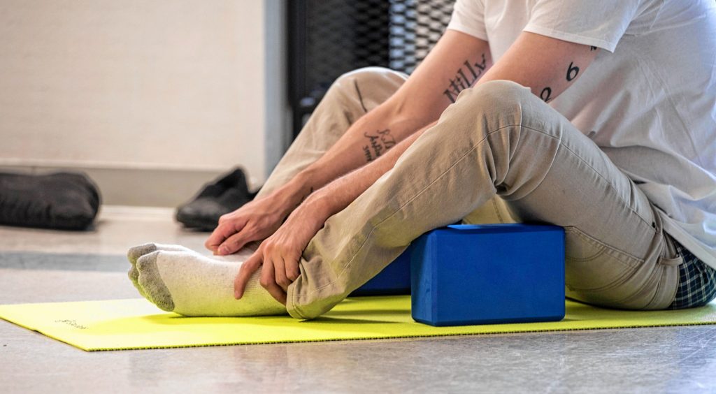 Shawn, an inmate at the Hampden County Pre-Release Center in Ludlow, takes part in a yoga class in the Cultivating, Honoring and Awakening Men's Potential program, or CHAMP, on Tuesday, April 30, 2019.