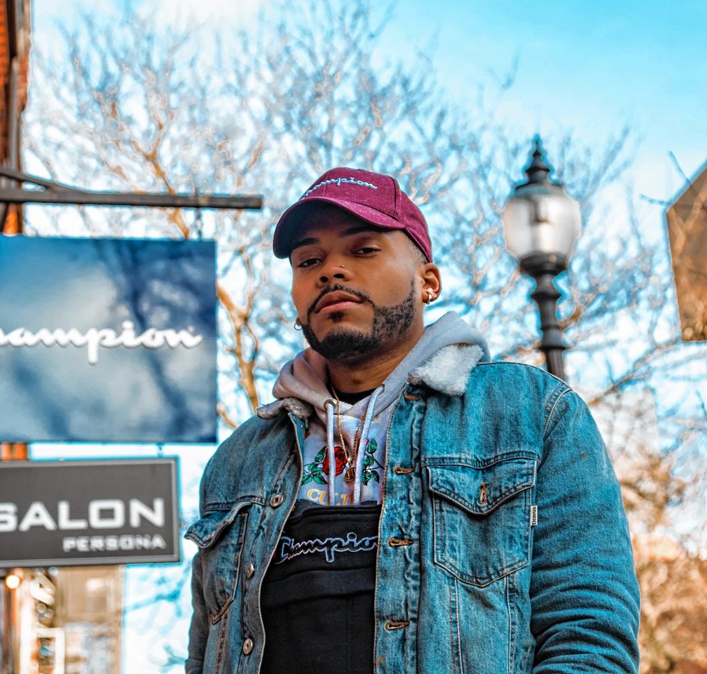 Springfield rapper Championxiii stands in front of a Champion store in Boston. He is not sponsored by the company, he said.