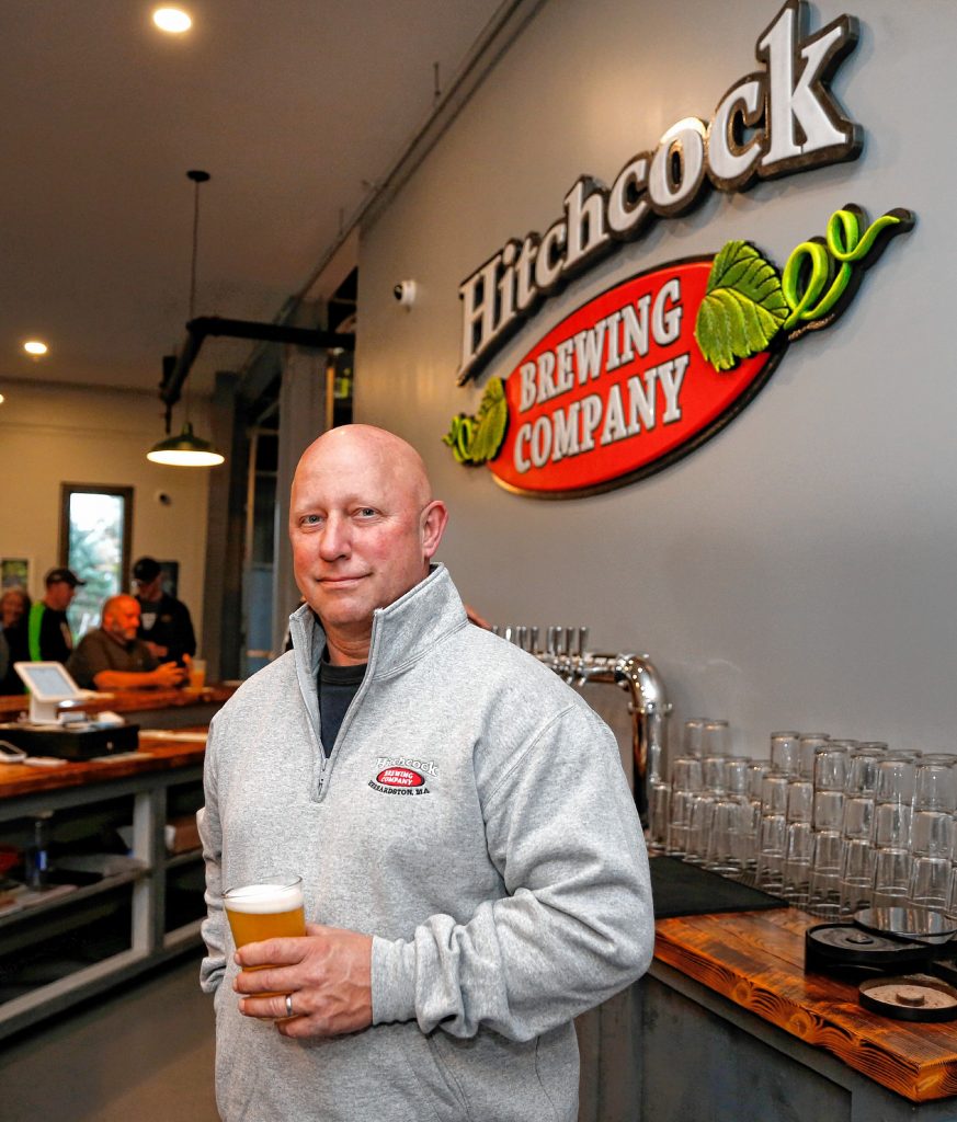 Hitchcock Brewing Company owner Rich Pedersen stands with a pint at the newly opened brewery and taproom at  203 South St. in Bernardston.