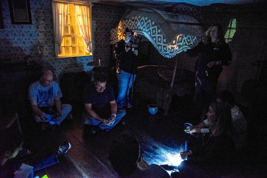 Liette Casey, upper right, with Agawam Paranormal leads an investigation in the upper floor of the 1754 Josiah Day House in West Springfield on Saturday evening, Sept. 14, 2019. The small lights are not from cell phones. Each of the participants carries with them at least one detection device - as well as a flashlight, if needed - during the investigations.