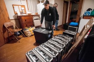 Agawam Paranormal senior investigator Heather Washburn of Southwick helps bring a score of equipment cases into the Josiah Day House in West Springfield for an investigation on Saturday evening, Sept. 14, 2019.