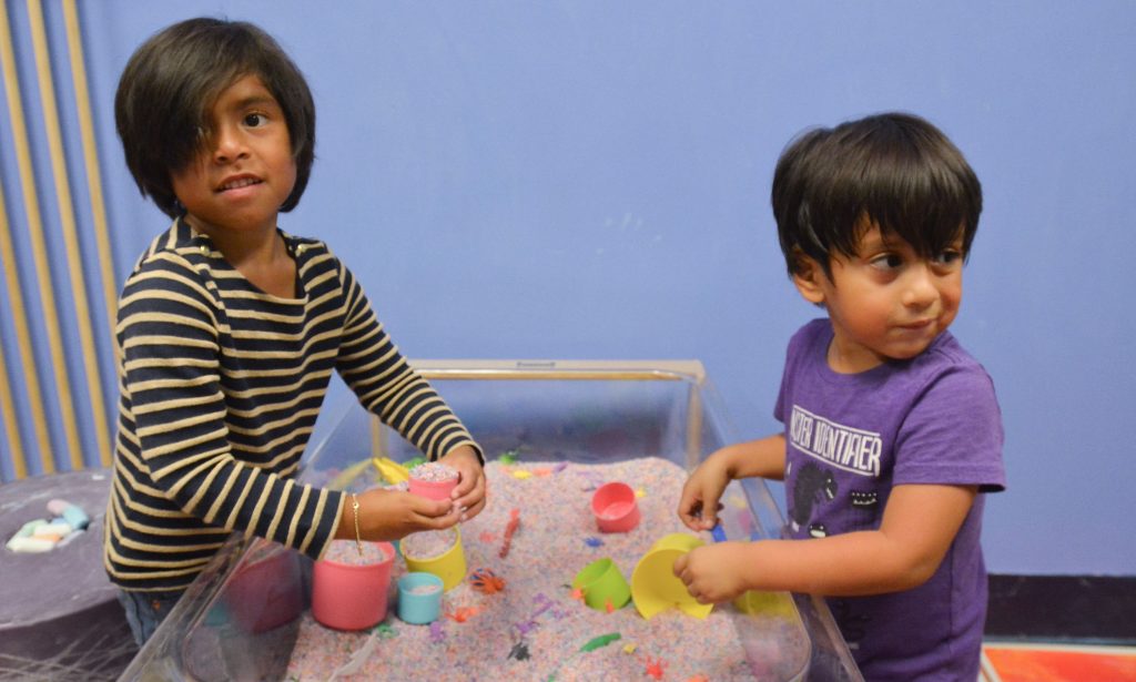 Esther Tibbitt, 5, and Ray Tibbiitt, 4, play on a sensory table, Friday at Holyoke Children's Museum. Though these children are not autistic and do not have sensory processing disorders, the activity is popular and suitable for those who do and is offered during the museum's Sensory Sundays. The children were with their grandmother, Peggy Tibbitt, of Belchertown.
