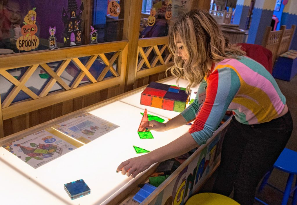 Lauren Boyce, who is the operations manager at Holyoke Children’s Museum, describes the use of a Magna Tile Table at the museum. It is one of the activities offered by the museum’s sensory Sundays.