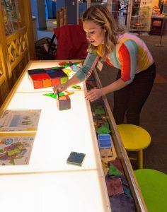 Lauren Boyce, who is the operations manager at Holyoke Children's Museum, describes the use of a Magna Tile Table, Friday, Oct. 25, 2019 at the museum. It is one of the activities offered by the museum's Sensory Sundays.