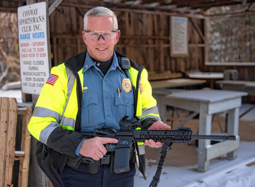 Ken Ouimette, with the Conway police department, poses with a  AR15 Patrol Riffle at the Conway Sportsman Club.
