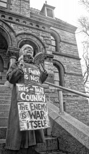 Claudia Lefko, one of the founders of the regular Saturday morning antiwar protest, with her sign on the steps of the courthouse.