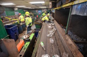 Workers separate different materials in the sorting room of the Springfield Materials Recycling Facility on Tuesday, Feb. 4, 2020.