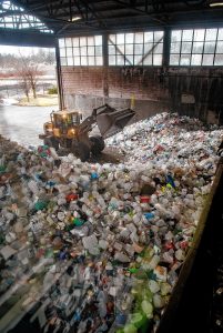 A frontloader consolidates a mound of plastic at the Springfield Materials Recycling Facility on Tuesday, Feb. 4, 2020.
