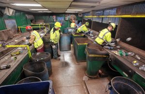 Workers separate different materials in the sorting room of the Springfield Materials Recycling Facility on Tuesday, Feb. 4, 2020.