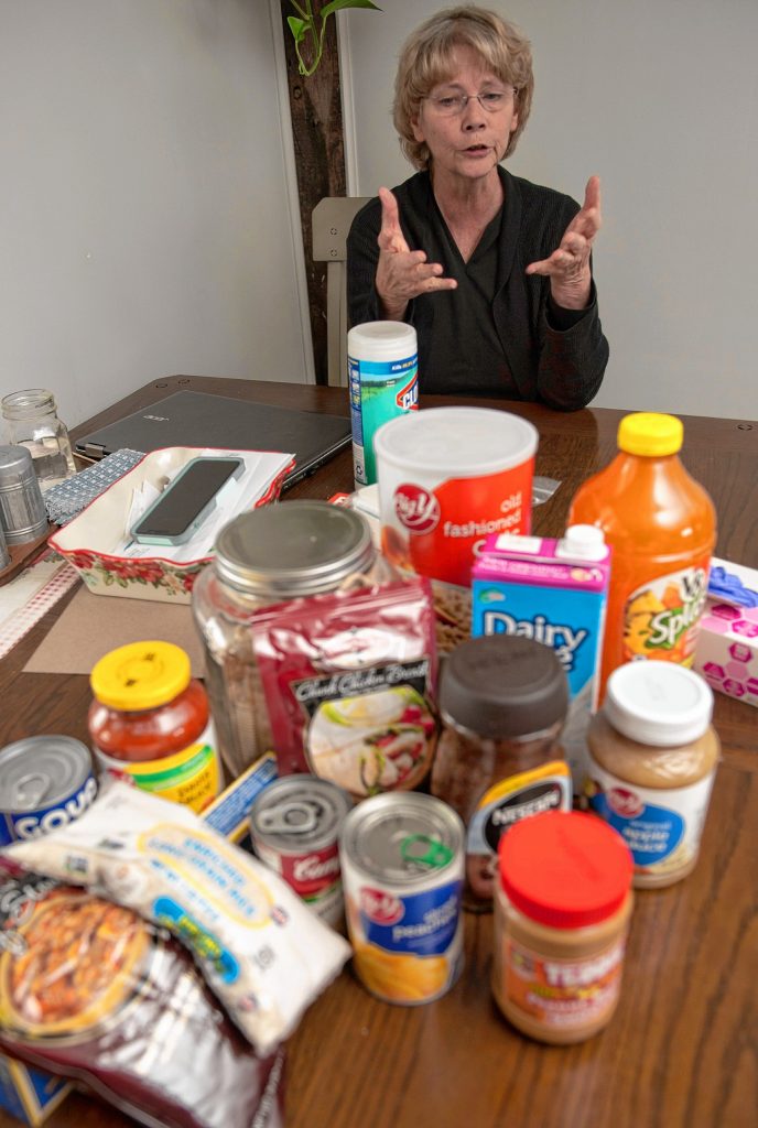 Kathy Harrison, author of “Prepping 101” and “Just in Case,” displays a range of grocery items she has stocked up in case of emergency. In the case of coronavirus, Harrison says people should have nonperishable food items on hand in case there is the possibility of a quarantine.