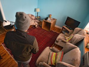 A man seeking asylum in the living room of his apartment, Tuesday, Feb. 11, 2020.