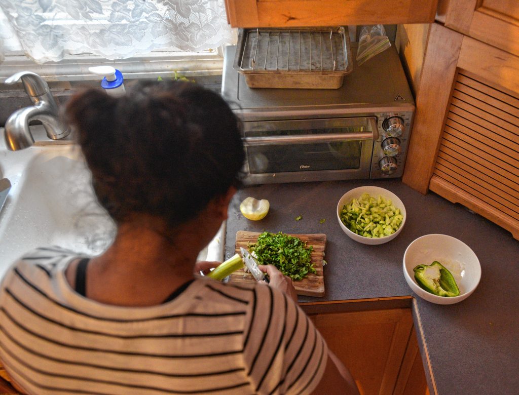 A woman who has been given asylum by Lynne cuts vegetables while making dinner, Thursday, Jan. 30.
