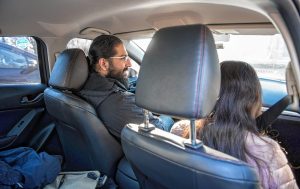 Western Massachusetts Asylum Support Network volunteer Osman Keshawarz, left, gives a ride to a woman, in the process of seeking asylum, from Hadley to the Immigration and Customs Enforcement office in Hartford on Wednesday morning, Jan. 29, 2020.