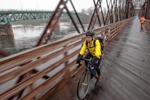 Physical therapist Jess Goldberg of Florence has regularly commuted by bicycle to her job in Hadley, a roughly 30-minute trip. Here she’s seen crossing the Connecticut River on the Norwottuck Rail Trail on her way to Tran's World Food Market in Hadley.