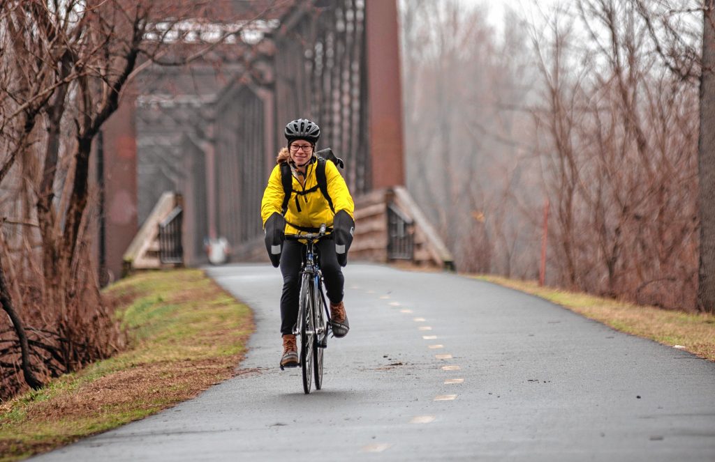Physical therapist Jess Goldberg of Florence has regularly commuted by bicycle to her job in Hadley. Here she’s seen on the Norwottuck Rail Trail on her way to Tran's World Food Market in Hadley.