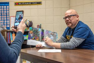 Dr. Marcella R. Kelly School Principal Luis Soria, right, and assistant principal Michelle Hernandez rehearse a reading of "Chato's Kitchen", by Gary Soto and Susan Guevara, in the office of the Holyoke elementary on Wednesday, March 25, 2020. Each day since schools have closed Soria tapes a video of himself reading a book aloud and posts it to the school's PTO Facebook site.