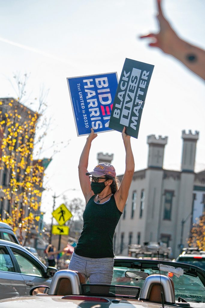 Elena Volpe, of Northampton, celebrates the election of Joe Biden, as cheering cars roll down Main Street Saturday in Downtown Northampton, MA.